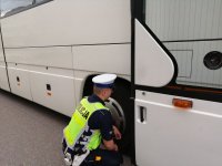 Policjant kontrolujący autobus.